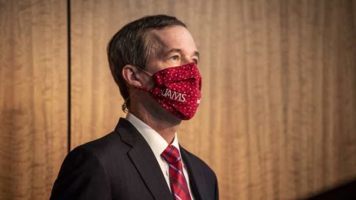 Dr. Patterson wearing mask standing at podium