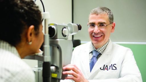 Doctor giving an eye exam to patient.